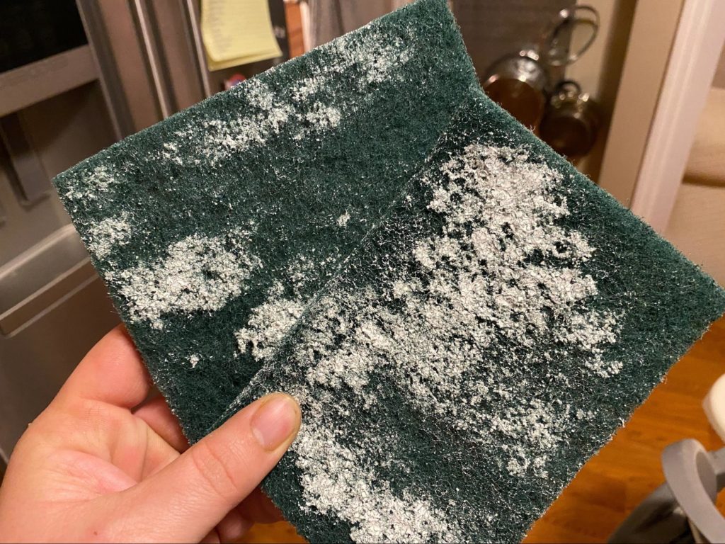3M scrub pad after cleaning a candle