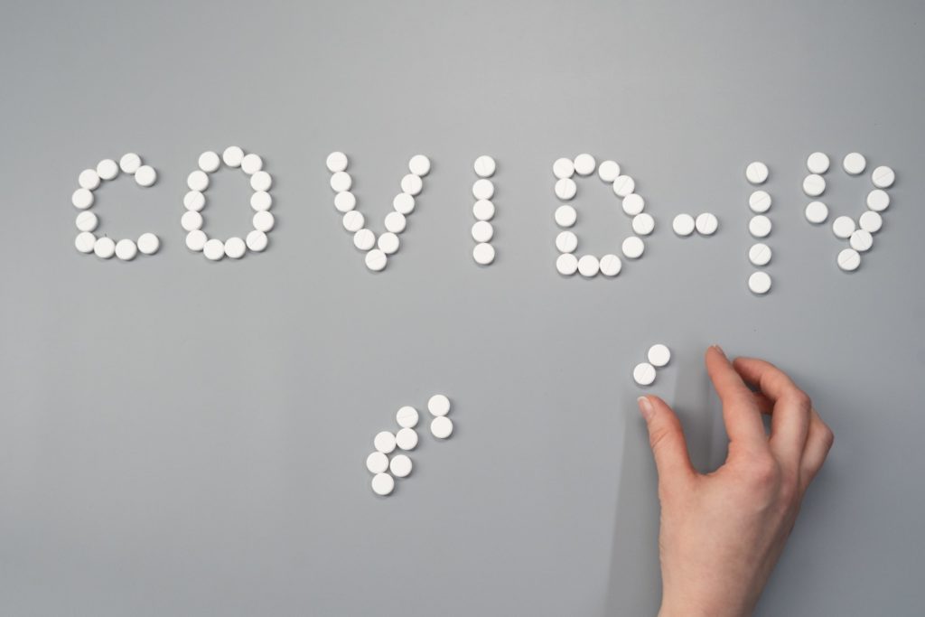 COVID pills on gray background