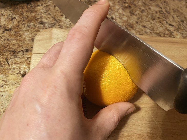 Slicing into an orange rind