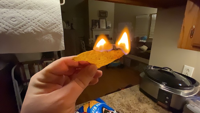 A fool holding a flaming chip