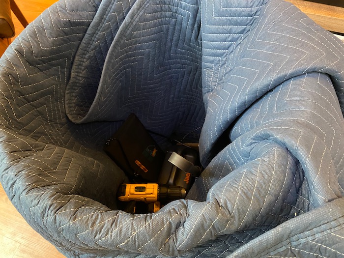 A moving blanket shoved into a trash can
