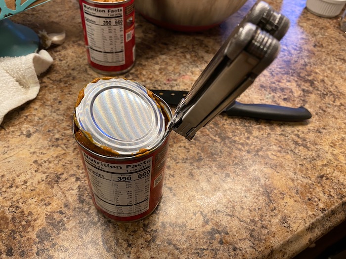 Cutting a can open with a knife