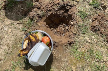 Pit dug and a bowl of refuse to throw in it