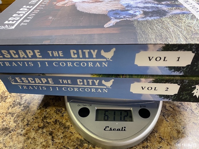 The two Escape the City books on a kitchen scale weighing 6 pounds, 11.2 ounces