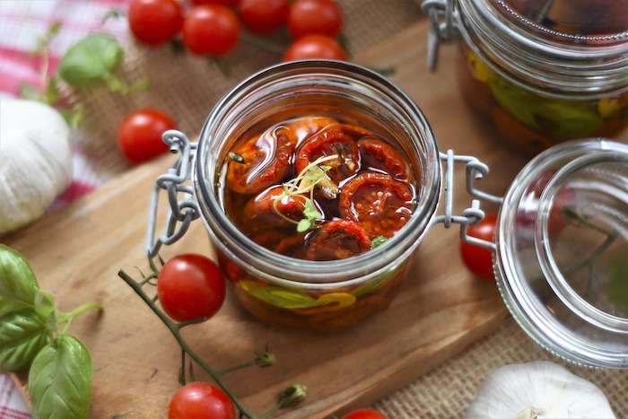 Tomatoes soaking in oil in a jar