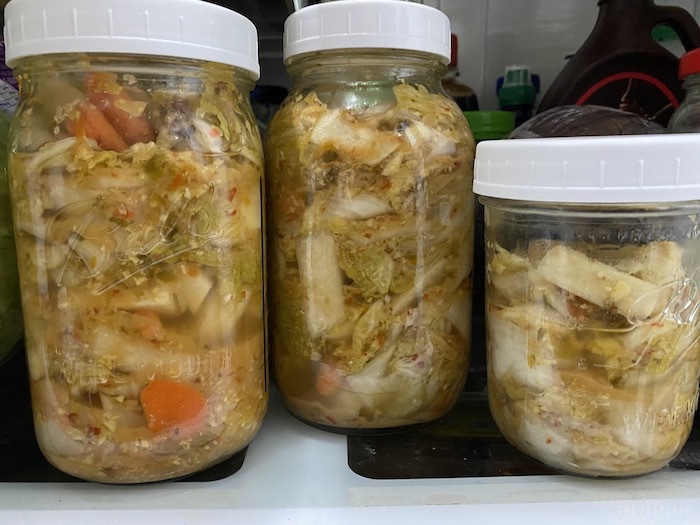 Jars of kimchi in the fridge.